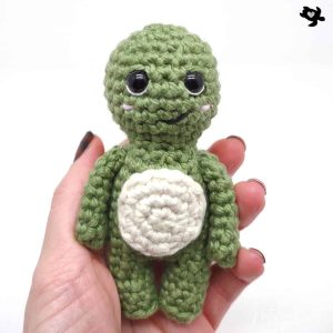 crochet tortoise in hand