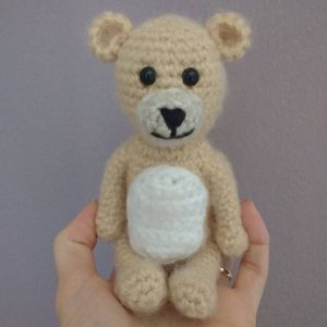brown crochet bear with white belly