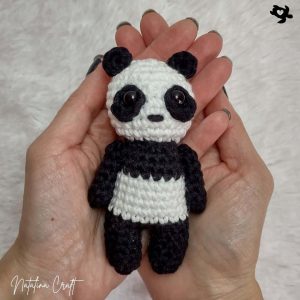 crochet panda in hands