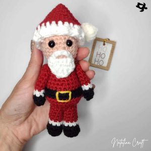 crochet santa in one hand