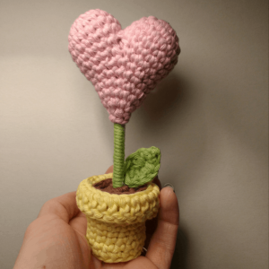 pink crochet flower heart in a yellow pot